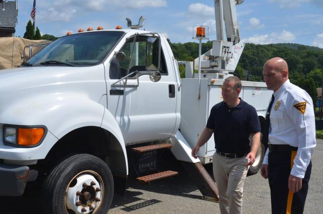 Franklin Police Detective-Lieutenant Nevin Mattessich shows a new bucket truck to U.S. Rep. Josh Gottheimer on Thursday.