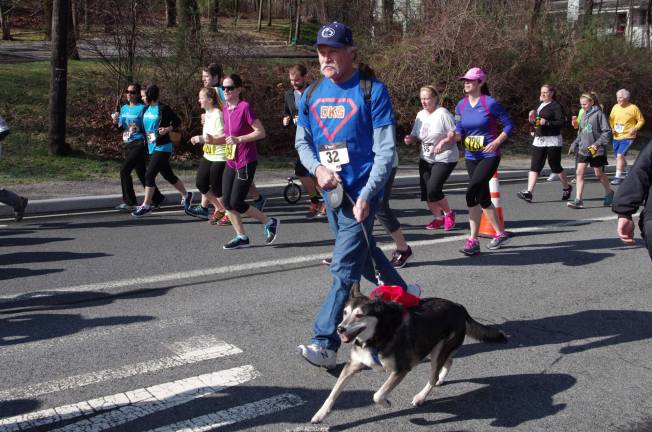 Sparta's Craig Calhoun and his dog Cassie run together.