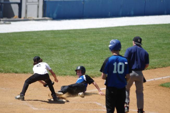 Wallkill's A.J. Sabatello attempts the tag as Kittatinny's Johnny Desordi arrives safe at home plate.