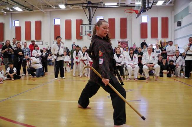 Martial artist Courtney Price demonstrates her skill with the cane in the weapons competition. Price won first place.