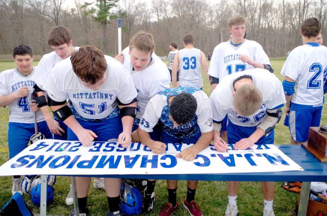 Kittatinny Cougars autograph their championship banner. Kittatinny Regional High School defeated Wallkill Valley Regional High School in boys varsity lacrosse on Monday, April 28, 2014. The final score was 20-5. Kittatinny clinched the NJAC Independence Division for its first championship in program history. The game took place at Kittatinny Regional High School in Newton, New Jersey.