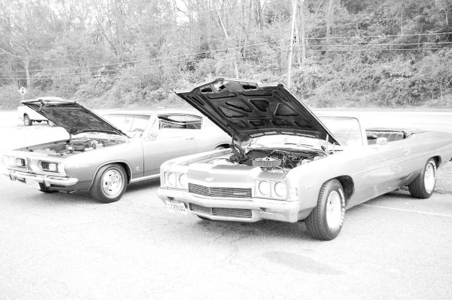 Classic cars cruise into Branchville A 1967 Plymouth Barracuda alongside a 1972 Chevrolet Impala Convertible.