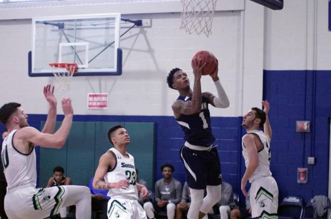 Camden County's Keshon Smith raises the ball towards the hoop during a shot in the first half.