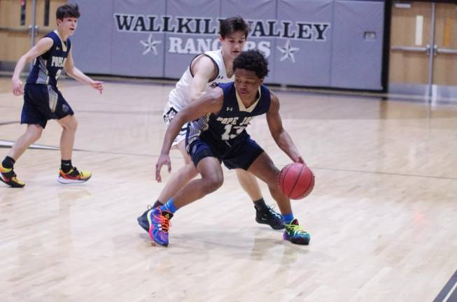 Pope John's Nurell Miranda dribbles the ball in the second half. Miranda scored 13 points.