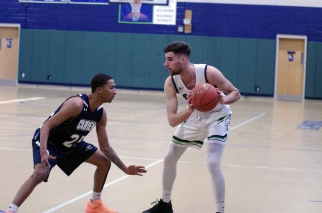 Sussex County's Reldi Durrsi Holds the ball while covered by Camden County's Christopher Roe in the first quarter.