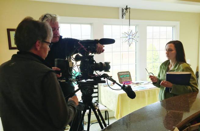 The film crew from Five Pebbles production company review footage shot at the Joseph T. Quinlan Bereavement Center.