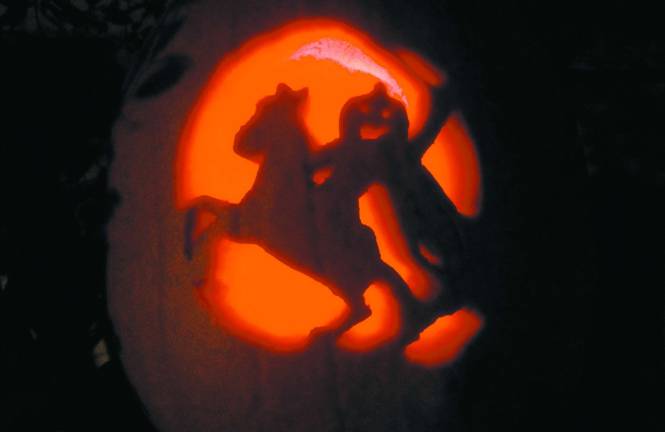 Carving it up Theresa Shields of Hamburg, N.J. Carving of a headless horseman jack-o-lantern.