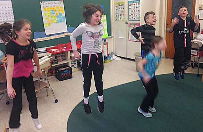 Samantha Fasolo, Erin Frawley, Makayla Snyder, Winston Hennings, Ryan Menczak play a Simon Says vocabulary game.