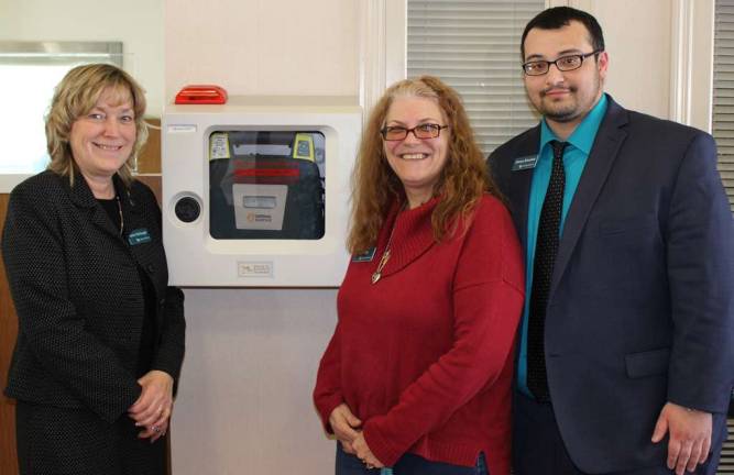 Lakeland Bank Area Branch Manager Karen McDougal stands with colleagues Catherine DiSalvo and Adnan Shoukat who recently assisted with using the onsite automated external defibrillator to help a customer having a heart attack at the Franklin Branch.