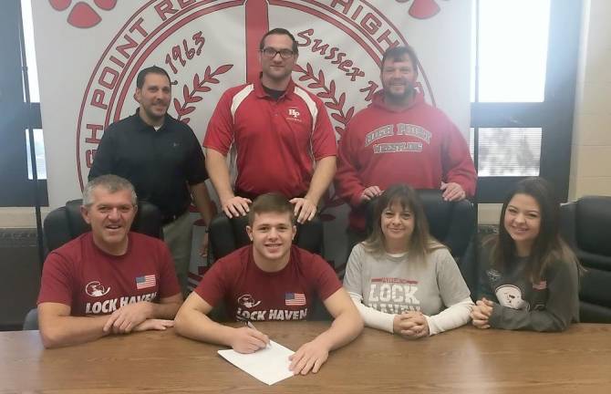 High Point's Billy Talmadge, seated middle, signs his National Letter of Intent to continue his wrestling career next year at Lock Haven University. Pictured seated from left to right are father William, Billy, mother Sheryl and sister Megan. Standing from left to right are assistant coaches Mark Veltri, Billy Smith, and Head Coach John Gardner.
