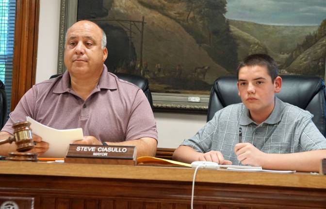 From left, Mayor Steve Ciasullo and student Deven Wylie listen to resident Jean Castimore's question about Heater's Pond Dam.