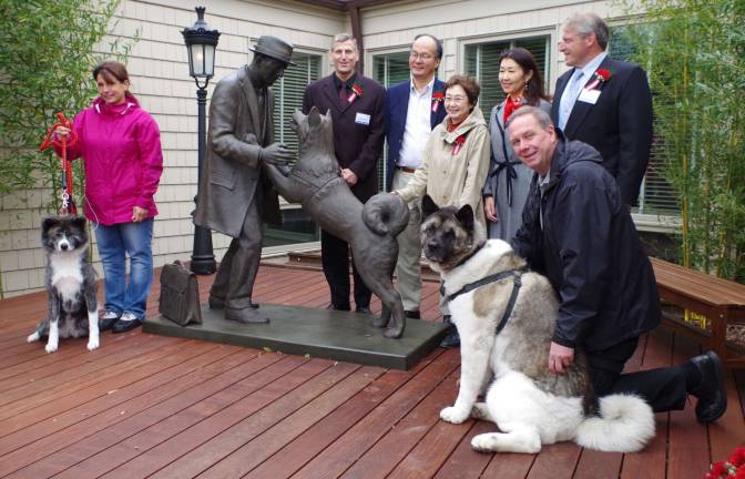 Dignitaries and guests are shown assembled beside the statue.