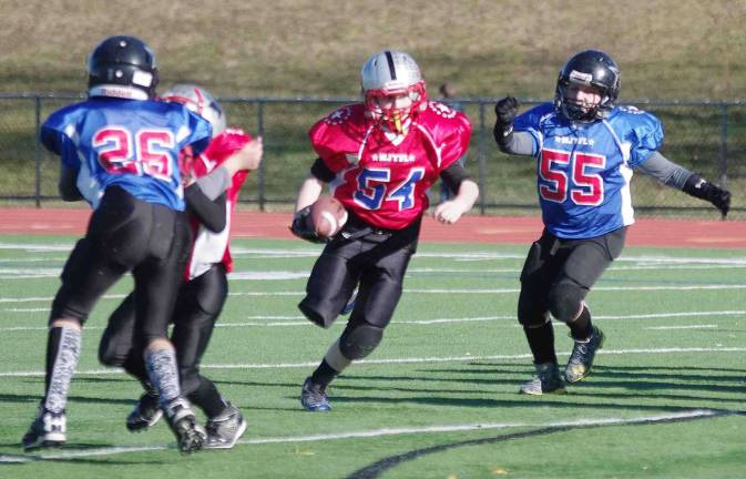 Red All-Star ball carrier Antonio Bullaro on the run in the Super PeeWees game. Bullaro plays for the High Point Hawks. The North Jersey Youth Football League All-Star games took place Saturday, December 5, 2015. Some of the best athletes from Passaic County and Sussex County, New Jersey in the 6th, 7th and 8th grade levels participated in three games. Macopin Middle School of West Milford, New Jersey hosted the event. The players were devided into two teams called the Red All-Stars and the Blue All-Stars. In the first game the Super PeeWees (6th grade) red all-stars defeated the blue all-stars by the score of 13-7. In the second game featuring The PeeWees (7th grade) the red all-stars and the blue all-stars ended the contest in a 6-6 tie. In the third game the Midgets (8th grade) the red all-stars defeated the blue all-stars 18-14.