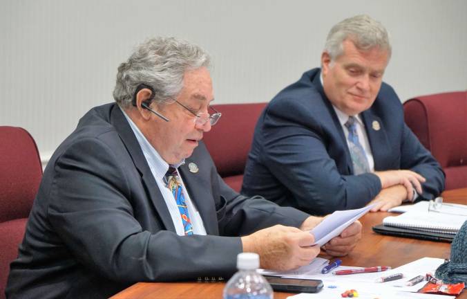 Freeholder Deputy Director Carl F. Lazzaro reads dollar amounts in the millions of around 13 bus and light rail projects put on hold, ranging from $12 million to $712 million.