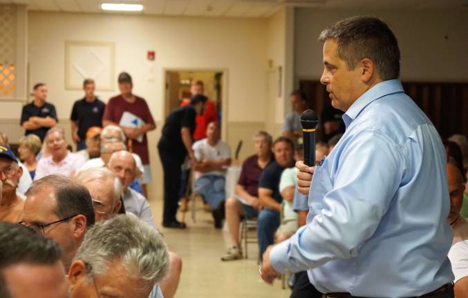 photO BY VERA OLINSKI The Elizabethtown Gas Director of Sales Gary Marmo, on right, answers residents' questions.