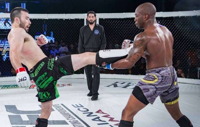 Jim Fitzpatrick (left) lands a kick in his bout against Bobby Malcolm at CFFC 65.