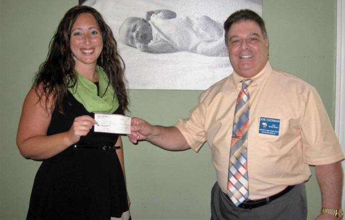 Tina Figurelli, executive director of Birth haven receiving Check from Joseph Ozoniak PGK of Knights of Columbus Council No. 5510.
