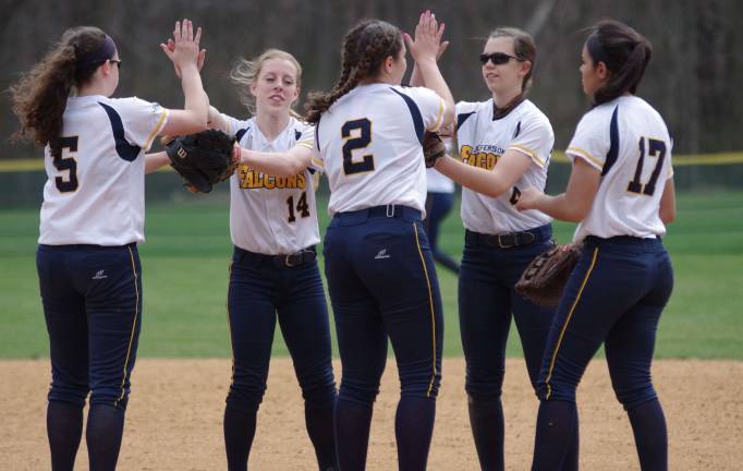 Several Jefferson Lady Falcons high five on the pitchers mound after pitcher Alexa Pettit threw a no-hitter.