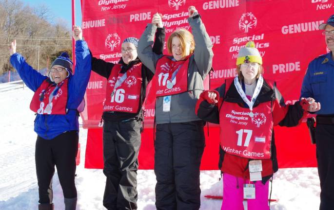 Vernon Mountaineers one again perform well at Special Olympics Shown during the cross-country skiing awards ceremony are Pauline Naturile, gold-medal winner and Vernon Mountaineer Karen Byrne, Joelle Bredon, and Vernon Mountaineer Teresa Kelly.