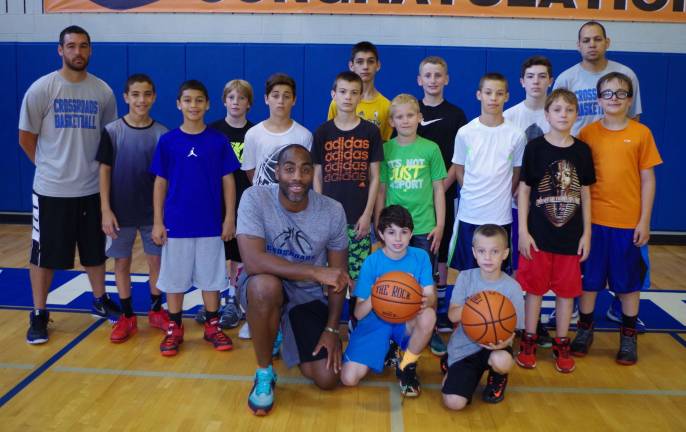 From left front row Crossroads Basketball Camp founder and coach Cornell Thomas with camp participants and coaches.