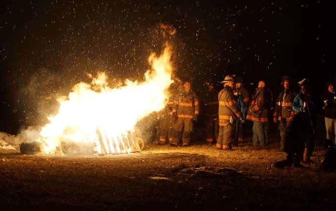 PHOTOS BY VERA OLINSKI Ogdensburg Volunteer fireman stand on call by the bonfire.