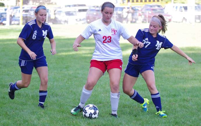 High Point Wildcat Brianna Simsic maneuvers the ball while challenged by Mountain Lakers.