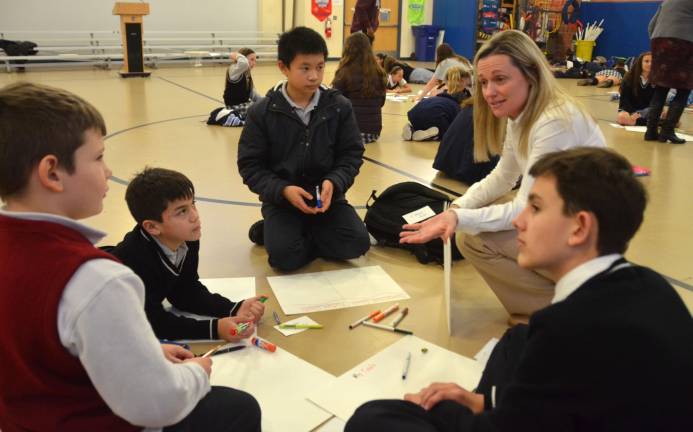 Reverend George A. Brown Memorial School principal Patricia Klebez, second from right, talks to a group of Catholic Academy of Sussex County students about its vision board during a Linking Lions meeting in November at Reverend George A. Brown Memorial School in Sparta.