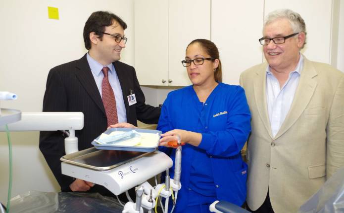 Chief Dental Officer Dr. Sam Wakim, dental assistant Julia Cruz, and dentist Dr. Michael Robinson are shown in one of two dental rooms. Robinson&#xfe;&#xc4;&#xf4;s trademark is his sense of humor that he uses to put patients at ease.