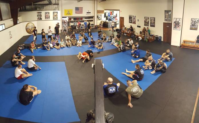 Newly promoted Black Belt Preston Gagg teaches during the charity BJJ seminar.