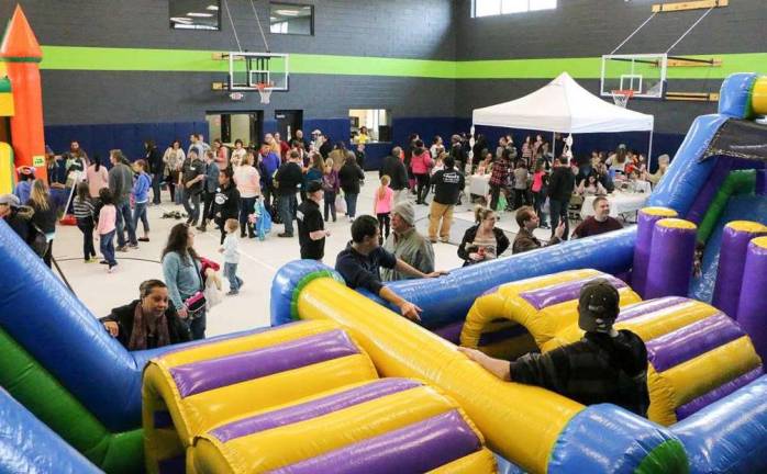 Christian Faith Fellowship holds family day Pastor Tom is shown by the giant inflatable.