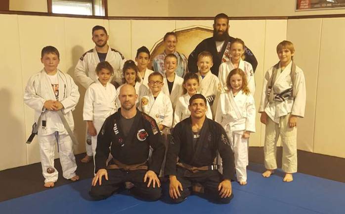 Miller Brothers MMA announces promotions Back Row L to R: Coach Joe Tizzano, Coach Brooke Fahey, Coach Frank Wallace; Third Row L to R: Shaan Balkar, Alexander Mizak, Josh Enberg, Lily Johnson, Eric Wittrien; Second Row L to R: Charles Hooey, Baseema Balkar, Iman Balkar, Anthony Reyes, Sophia DeNapoli, Elizabeth O'Brien; Front Row L to R: Coach Moe Johnson, Head Coach Mike Pagano