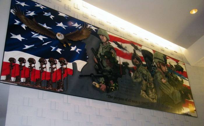 The veterans mural, completed by Sussex artist Art Frisbie in 2008, displays the famous St. Augustine quote &quot;The purpose of all wars is peace&quot; at bottom.