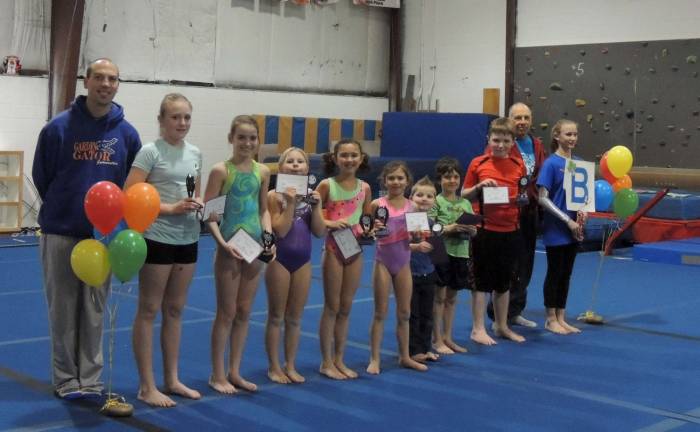 Coaches John Skorski and Bob Schutz present awards to their gymnasts from Tumbling and Boys classes.