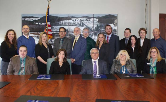 SCCC President, Dr Paul Mazur (Center), is seated among the administration, faculty and staff of both Berkeley College and Sussex County Community College for the signing of an articulation between both colleges. The signing took place in the board room at SCCC on Thursday, Dec. 4.