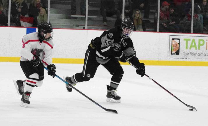 Parsippany Regional's Frank Baccaro steers the puck as High Point-Wallkill Valley's Brandon Mudrick keeps pace.