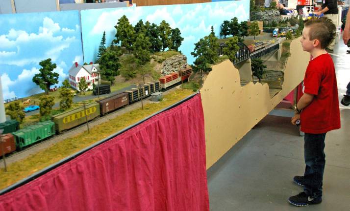 Noah DeGraw, 7, of Franklin watches as a freight train goes chugging by. Model railroad show is an established favorite.
