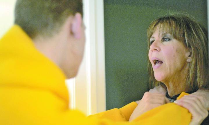 Maureen Morella guides her son, Jesse, back to his room after some physical therapy exercises.