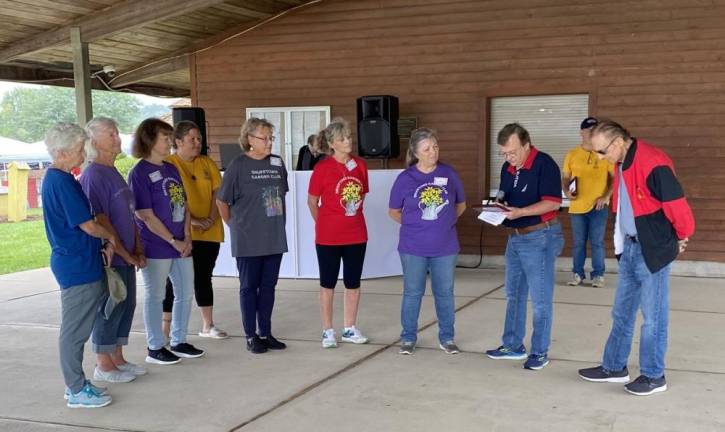 Hardyston Mayor Brian Kaminski, econd from right, presents Snufftown Garden Club president Rose Wolverton, third from right, and club members with the Mayor’s Volunteer of the Year Award for 2023. (Photo provided)