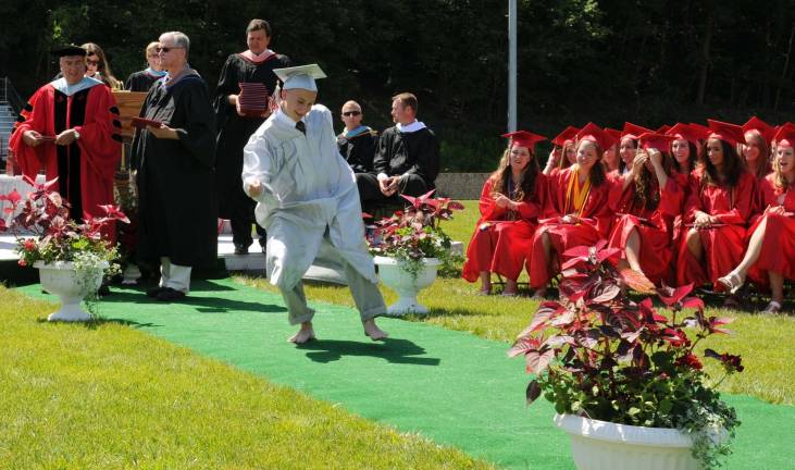 Hi-jinks at High Point graduation With diploma in hand, Paul Derrin does a barefoot dance.