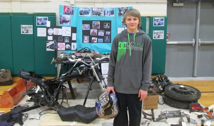 Nick Kinney is shown with his motorcycle project.