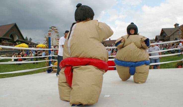 Two days of beer and bratwurst Under stormy skies sisters Suzy Lind of Nyack, N.Y. (left) and Jennifer Lind of Pompton Plains donned sumo outfits for a wrestling match.
