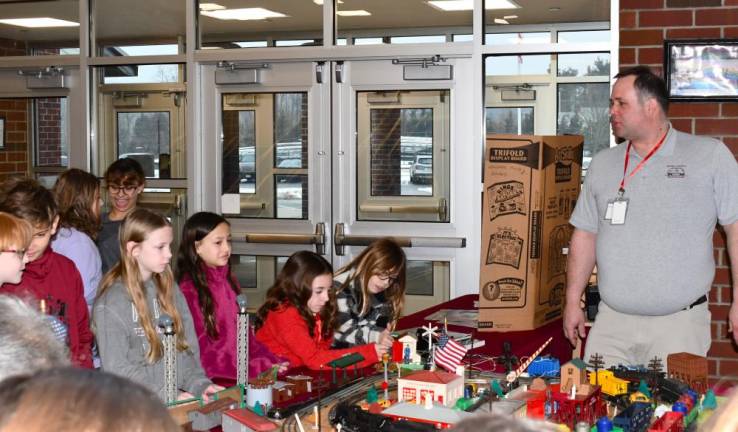 Sussex County Railroad Club member Steve Zydon shows students the model trains.