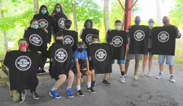 Students and mentors receive their Final Round tee-shirts, with photographer Paul Michael Kane on far right (Photo by Vera Olinski)