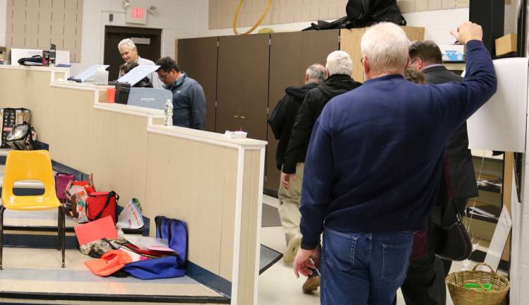 PHOTO BY MARK LICHTENWALNER Voters wait for their turn to vote in the Wallkill valley music room.