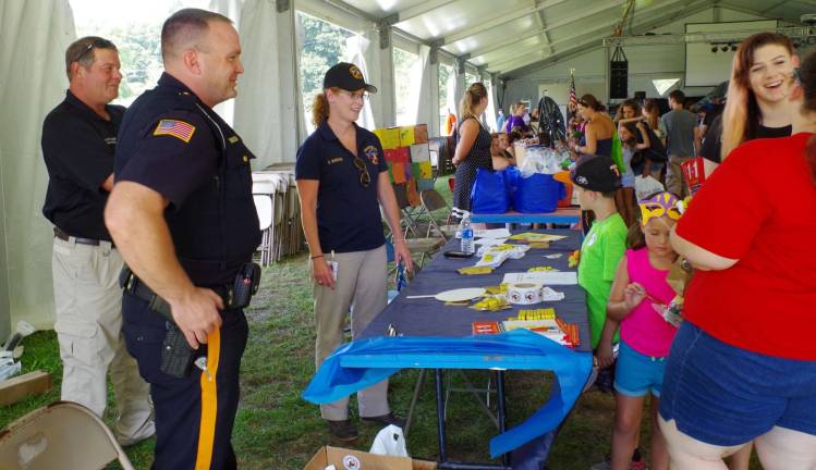 The Sussex County Sheriff&#xfe;&#xc4;&#xf4;s Department was there to offer free crayons and stick-on patches. Attending to the table are from the left Ken Armstrong, Lou LaBar, and Hilary Manser.