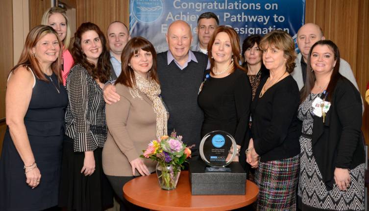 NASA astronaut Dr. Story Musgrave (center) celebrated the Pathway to Excellence designation with Chief Nursing Officer Debbie Regen (in black, to the right of Dr. Musgrave). Also pictured are members of the Pathway to Excellence Committee at Saint Clare&#xfe;&#xc4;&#xf4;s.