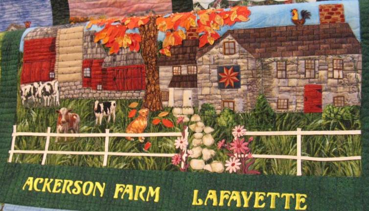Closeup of Ackerson Farm patch, showing applique levels, outline work, embroidery and painted details, like door hinges. Part of quilt of historic farms in Sussex County, N.J., by Winnie Jager (Photo by Ginny Privitar)