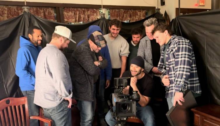 Talking to filmmaker Kevan Ali The cast watches the dailies with Kevan Ali, who is standing behind the camera in a blue hoody. (Photos provided)