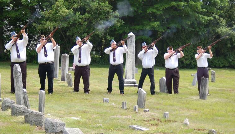 The Firing Squad fires a three-shot volley at the Oak Ridge Cemetery as part of the services held honoring the Veterans who are buried there.