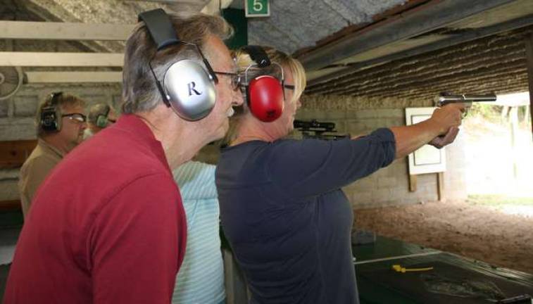 Shooting coach Vic Ferrara watches student Diane Teja.